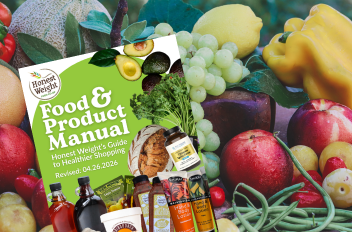 Background is fresh fruits and greenery with a copy of the Honest Weight Food and Product Manual Cover