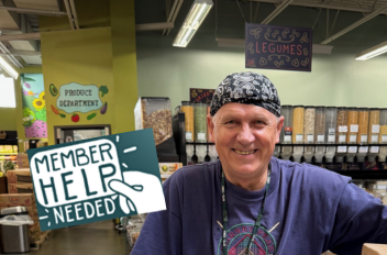 Photo of a man smiling in a grocery store with an icon reading "member help needed"